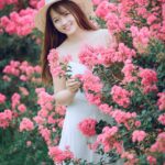 woman behind pink flowers
