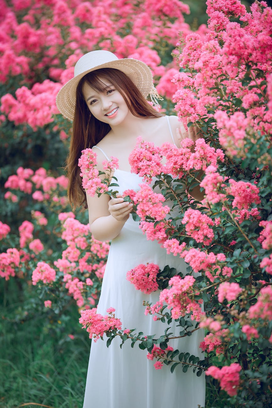 woman behind pink flowers